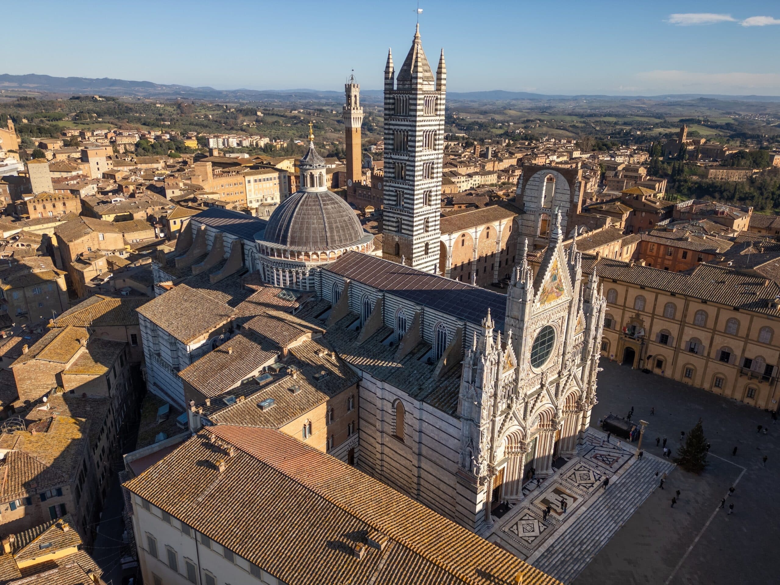 This aerial drone photo shows the cathedral of Siena, also known as Duomo di Siena. Siena is a town in Tuscany, Italy.