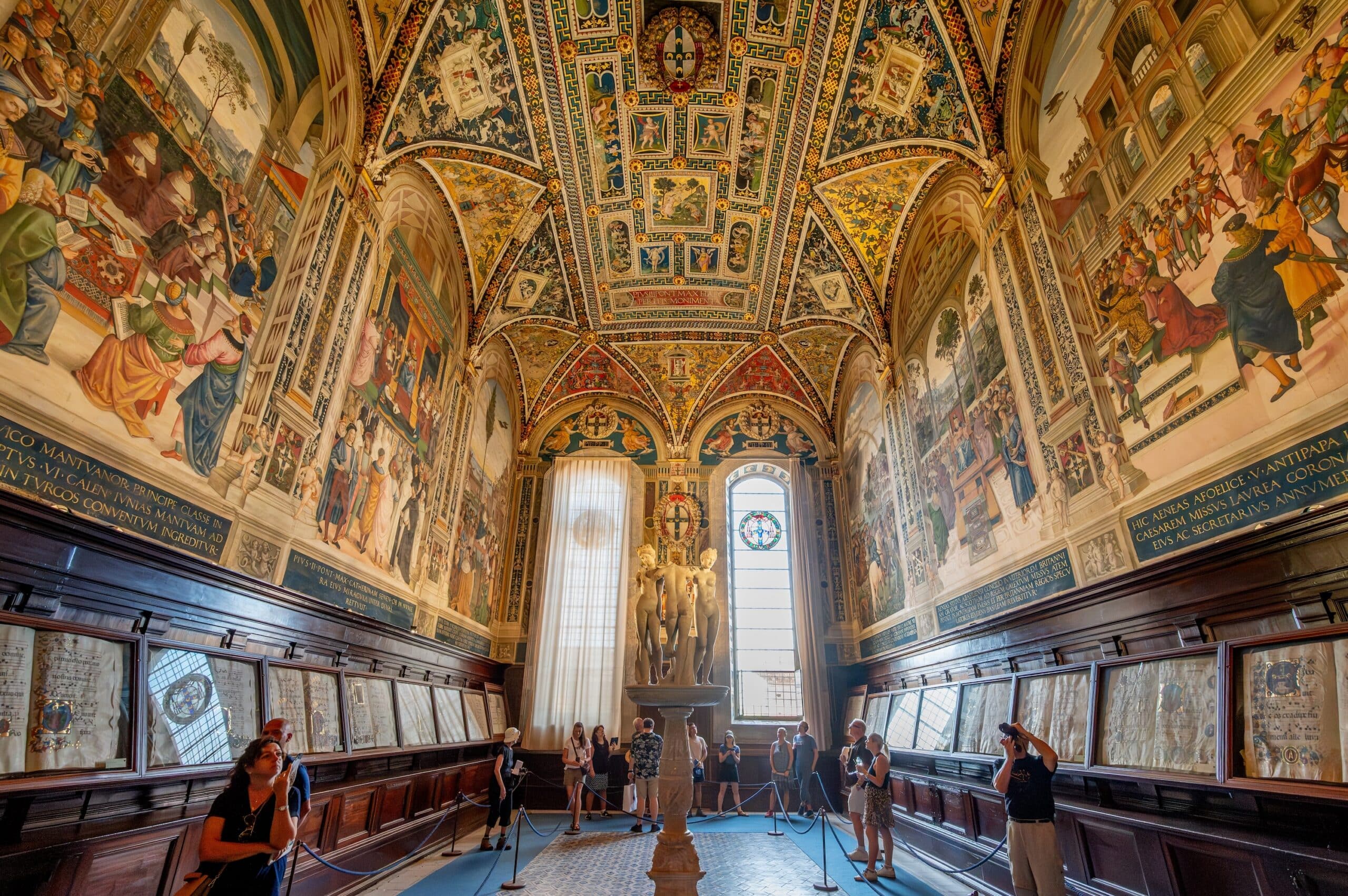Siena, Italy - Aug 9,2023: A detailed view of the Piccolomini Library inside Siena Cathedral, featuring Renaissance frescoes and a stunning ornate ceiling.