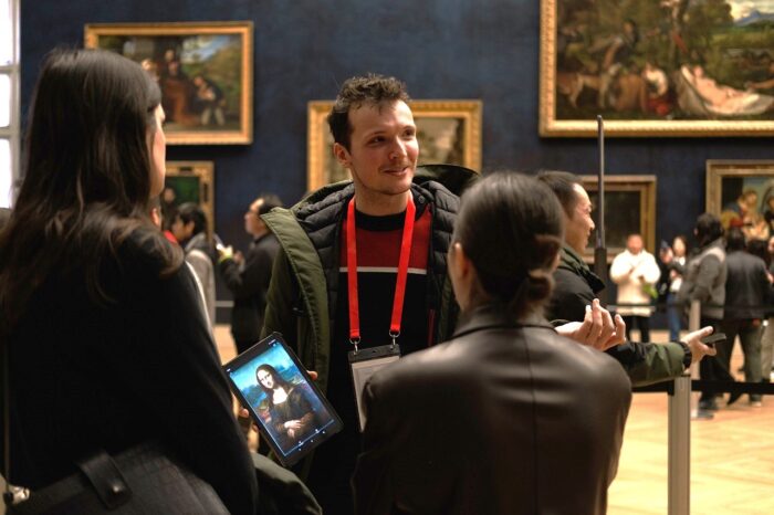 Paul Doucette et al. looking at a phone
