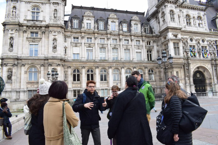a group of people walking in front of a building