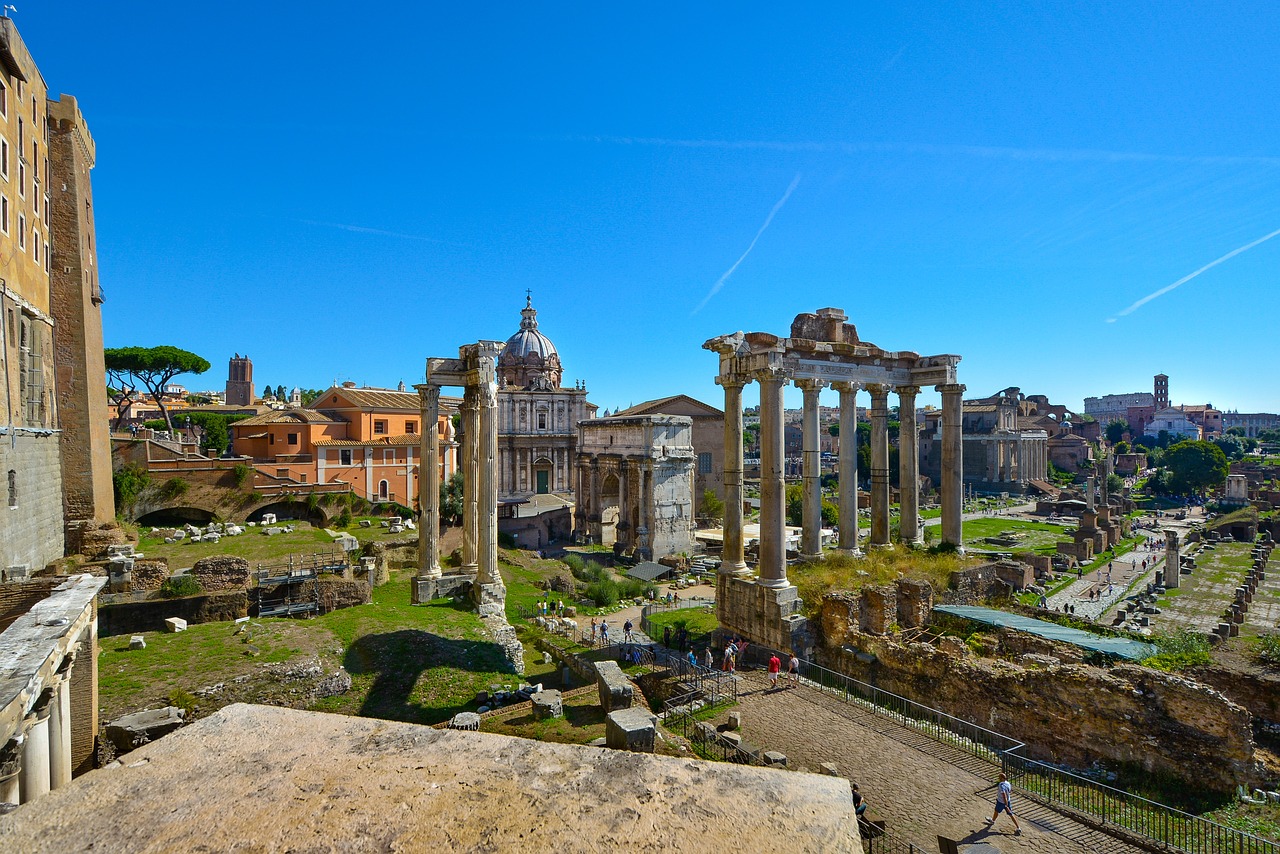 a view of a stone building with Roman Forum in the background