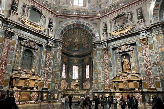 a group of people standing in front of Medici Chapel