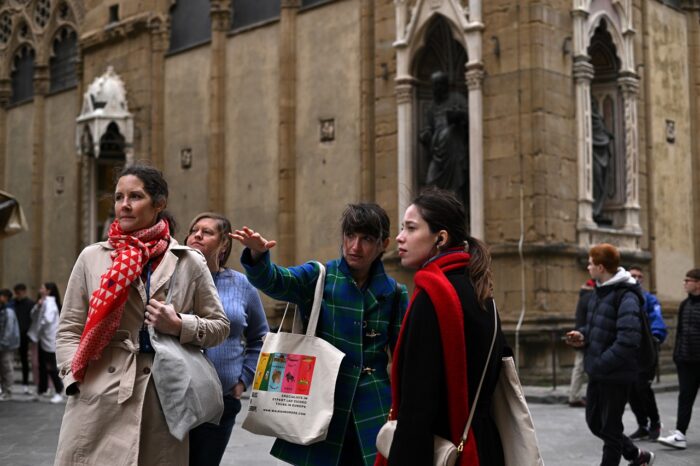 a group of people walking on a city street