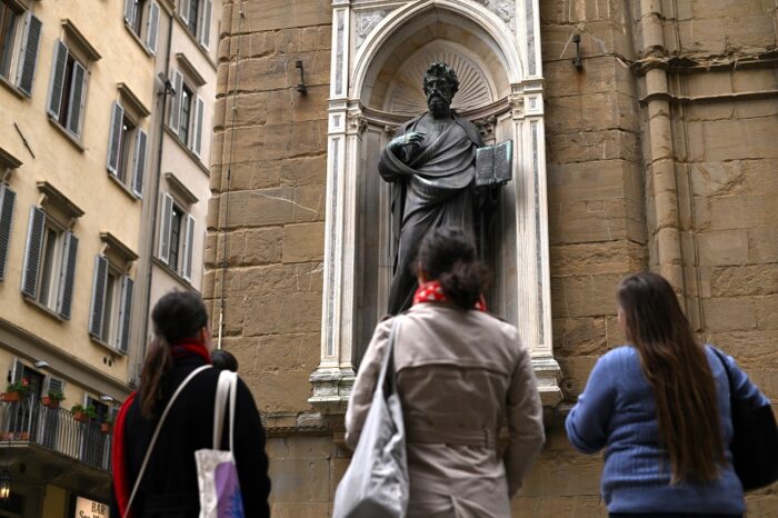 a group of people walking in front of a building