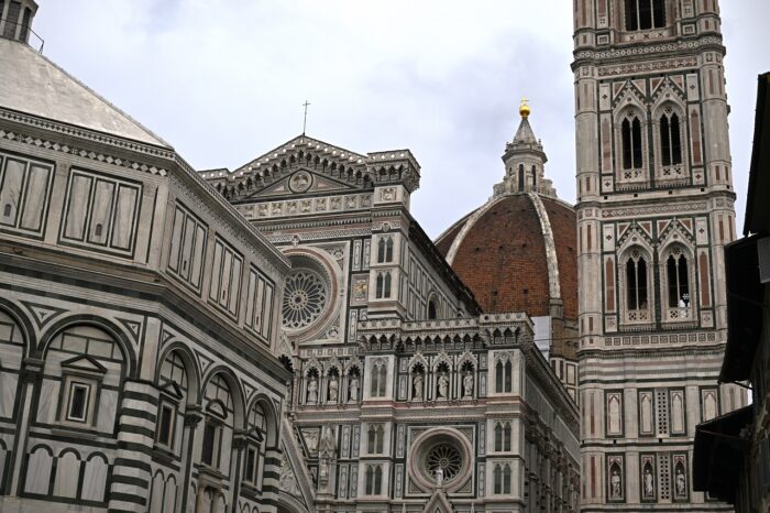 a large clock tower in front of Florence Cathedral