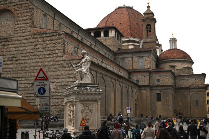 a group of people walking in front of a building