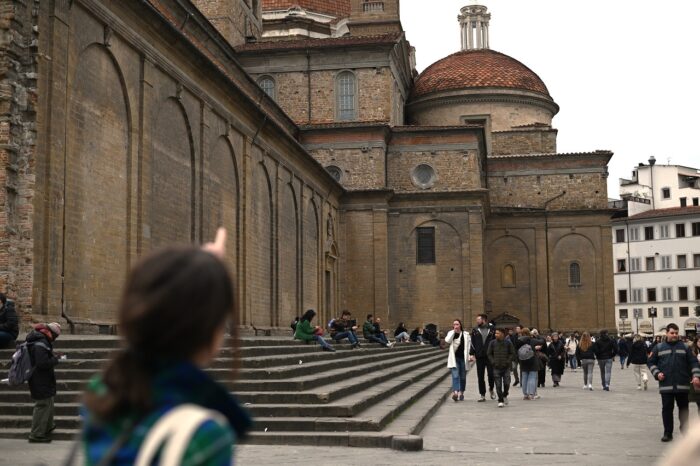 a group of people walking in front of a building