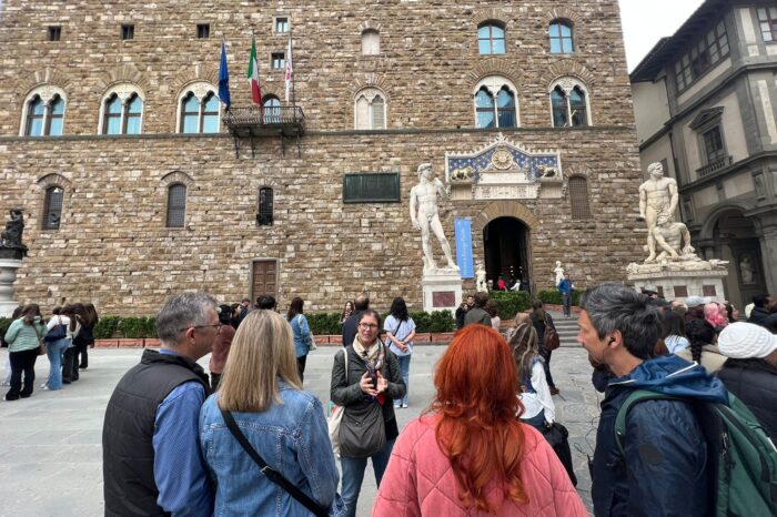 a group of people standing in front of a castle