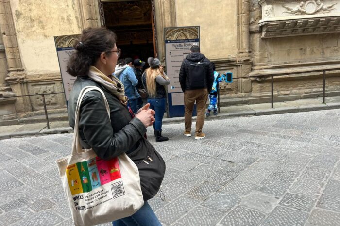 a person walking down the street talking on a cell phone