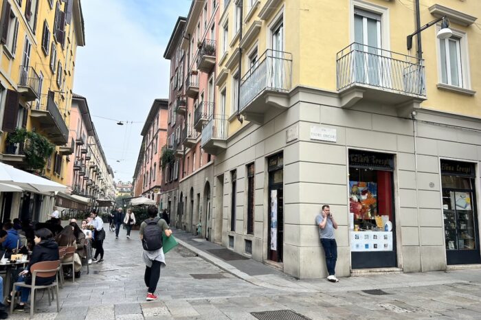 a group of people walking on a city street