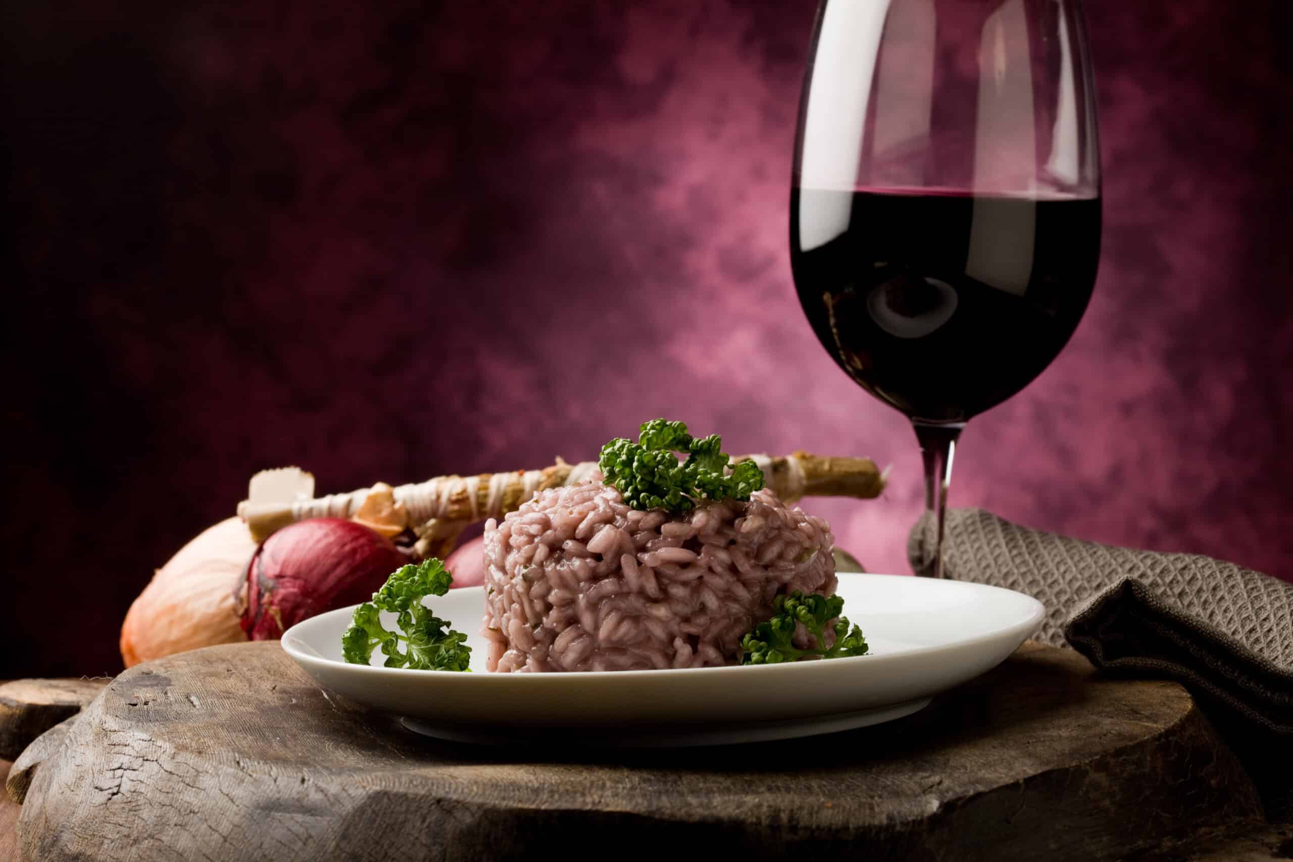 Photo,Of,Delicious,Risotto,With,Red,Wine,On,Wooden,Table