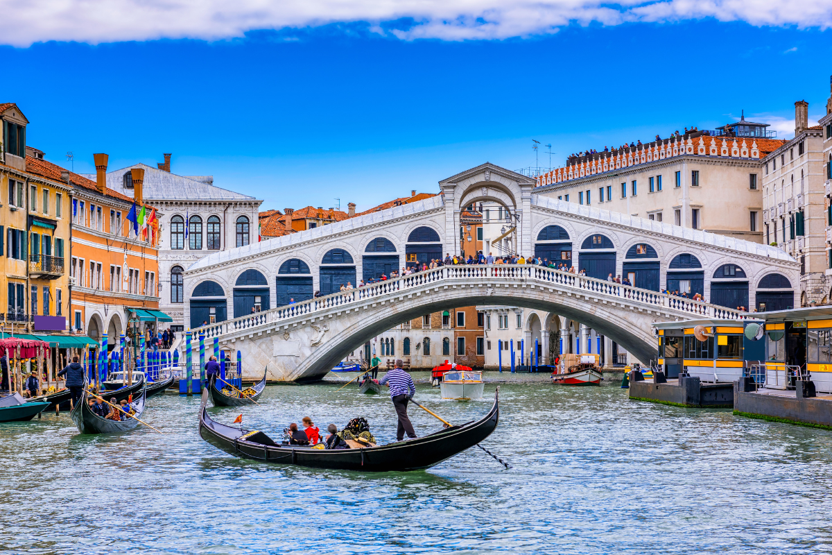 Rialto Bridge and gondola on Venice's Grand Canal, corporate travel program destination in Italy