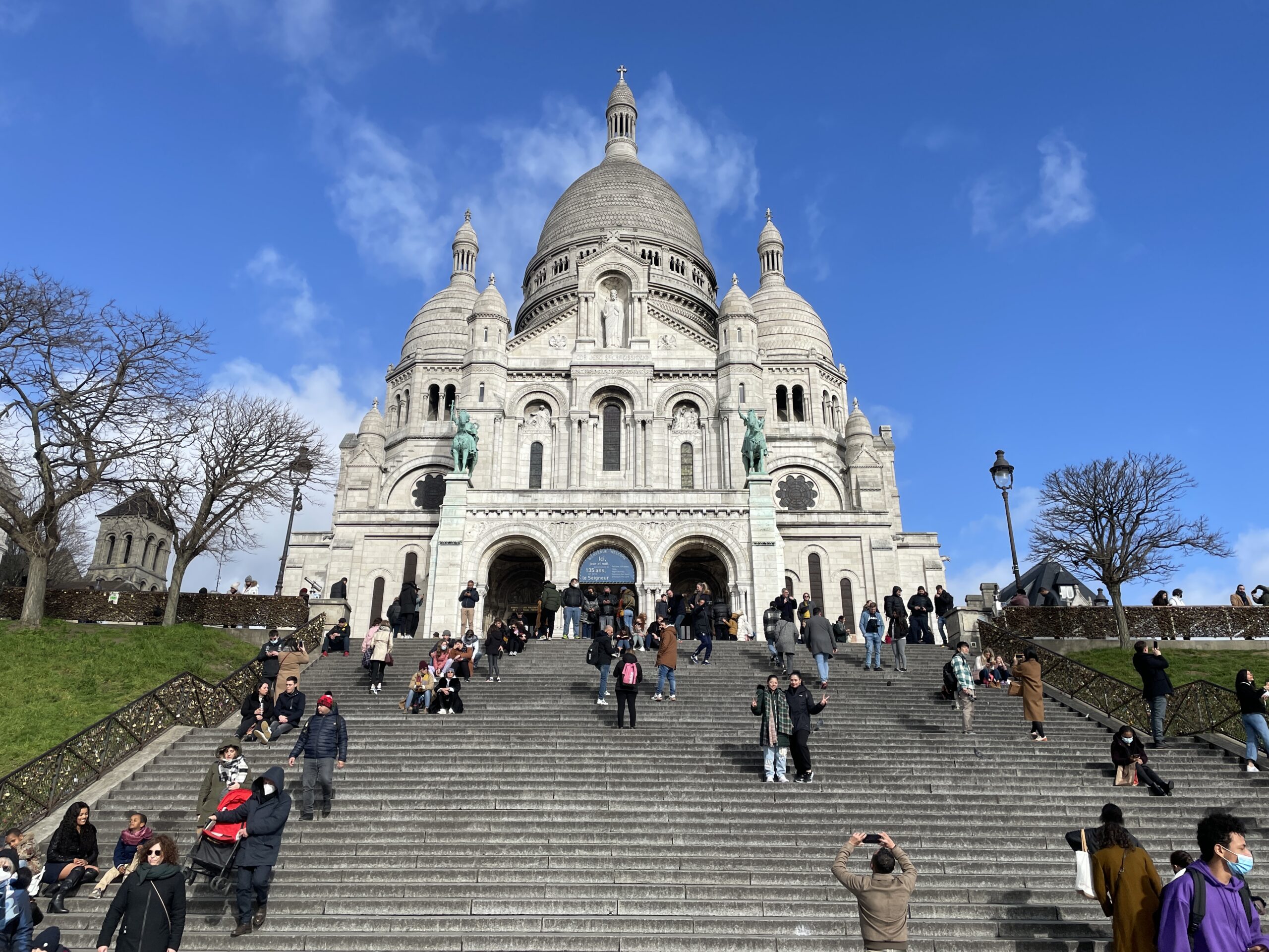 Sacre Coeur Basilica and its steps in Montmartre, Paris, on a clear day