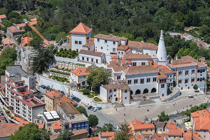 a large building with a mountain in the background