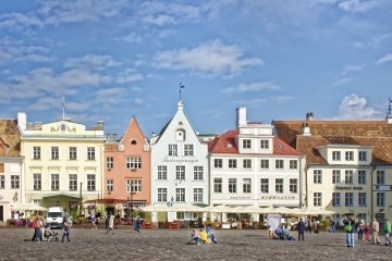 a group of people walking in front of a building