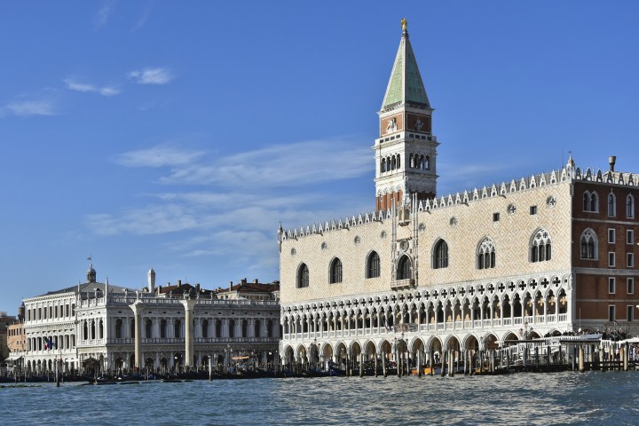 a castle with water in front of a building