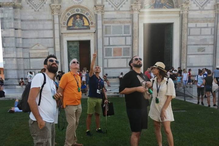 a group of people that are standing in the grass