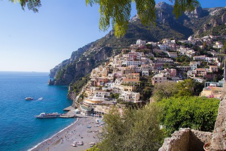 a large body of water with Amalfi Coast in the background