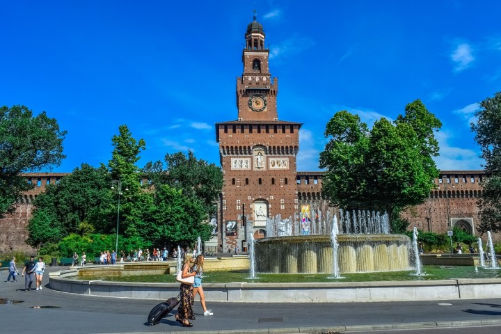 a clock tower in the middle of a road
