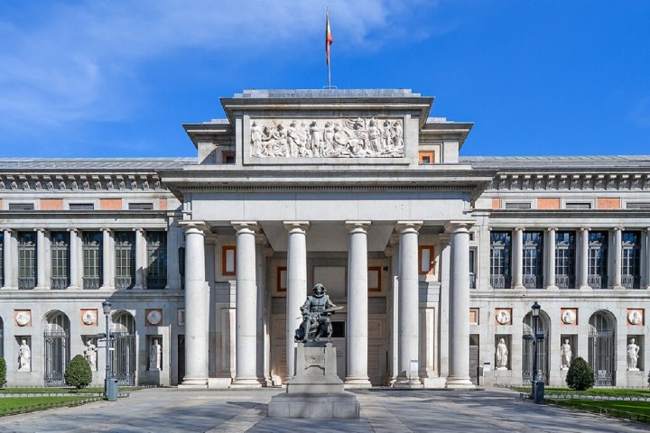 a large stone building with Museo del Prado in the background