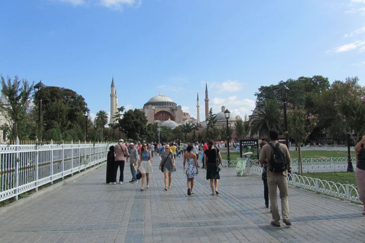 a group of people walking on a bridge