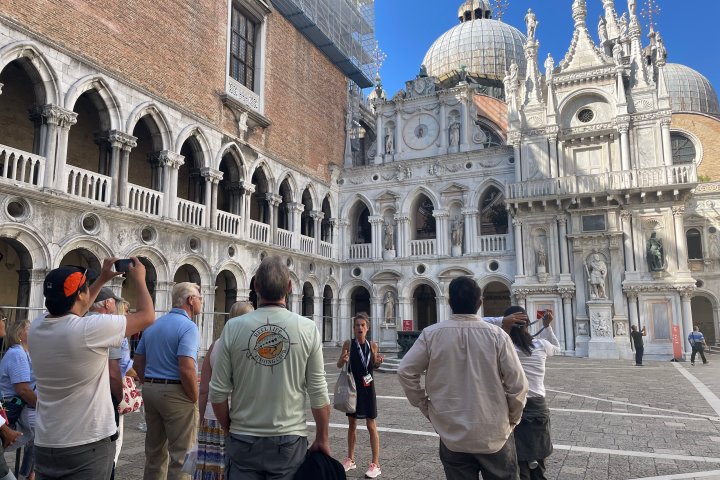 a group of people standing in front of Doge's Palace
